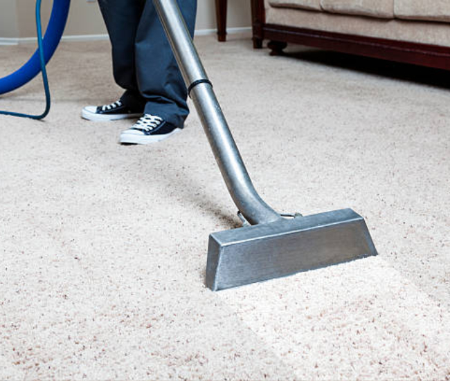 Residential carpet cleaning in progress inside a home, with deep-cleaning equipment removing dirt and stains from living room carpet to restore freshness and comfort